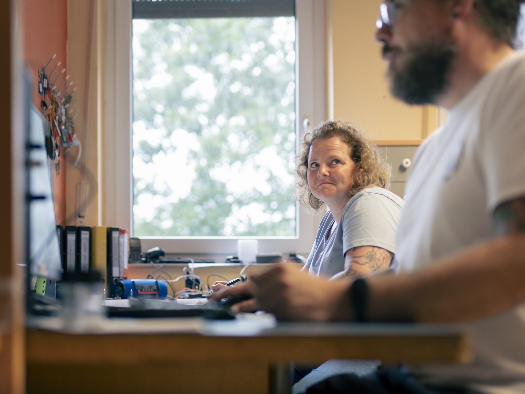 Eine Frau und ein Mann arbeiten am Schreibtisch im Büro der Behindertenhilfe Haus Nettetal 